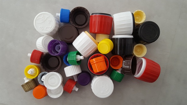 Many colored screw caps in a pile