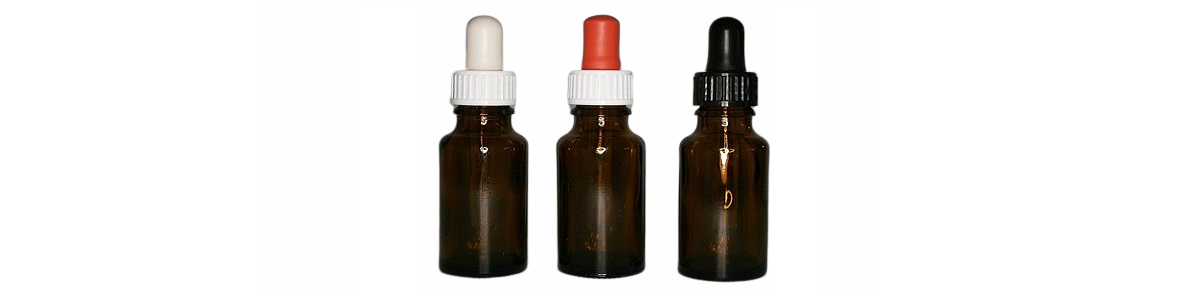 3 dropper bottles next to each other in brown with pipette suction cups in white, red and black