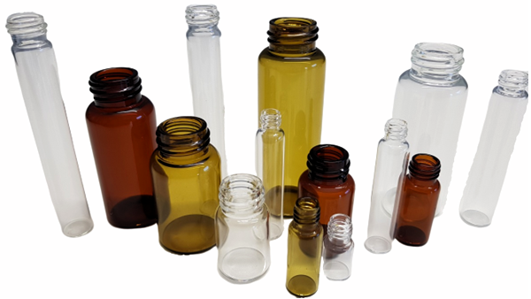 Several threaded bottles in clear and brown in a group
