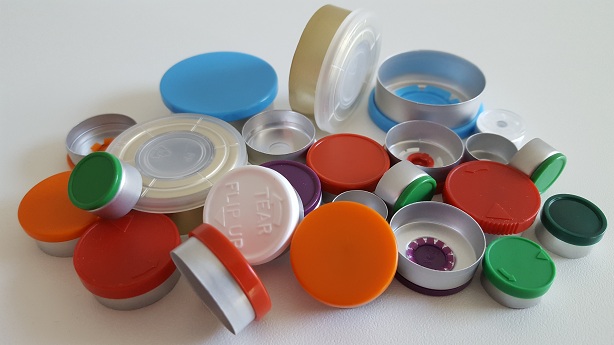 Many aluminum caps with colored plastic lids in a pile